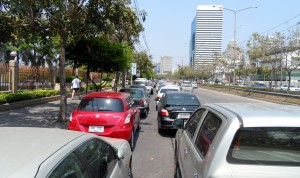 Cars parked two rows deep on the main road.