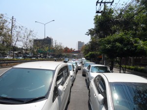 Cars parked two rows deep on the main road.