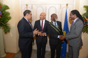 Governor-General of Jamaica, Sir Patrick Allen (2nd left), exchanges pleasantries with Minister of Tourism and Entertainment, Dr. Wykeham McNeill (left), as State Minister for Tourism and Entertainment,  Damion Crawford (right) congratulates the Poet Laureate of Jamaica, Professor Mervyn Morris (2nd right). 